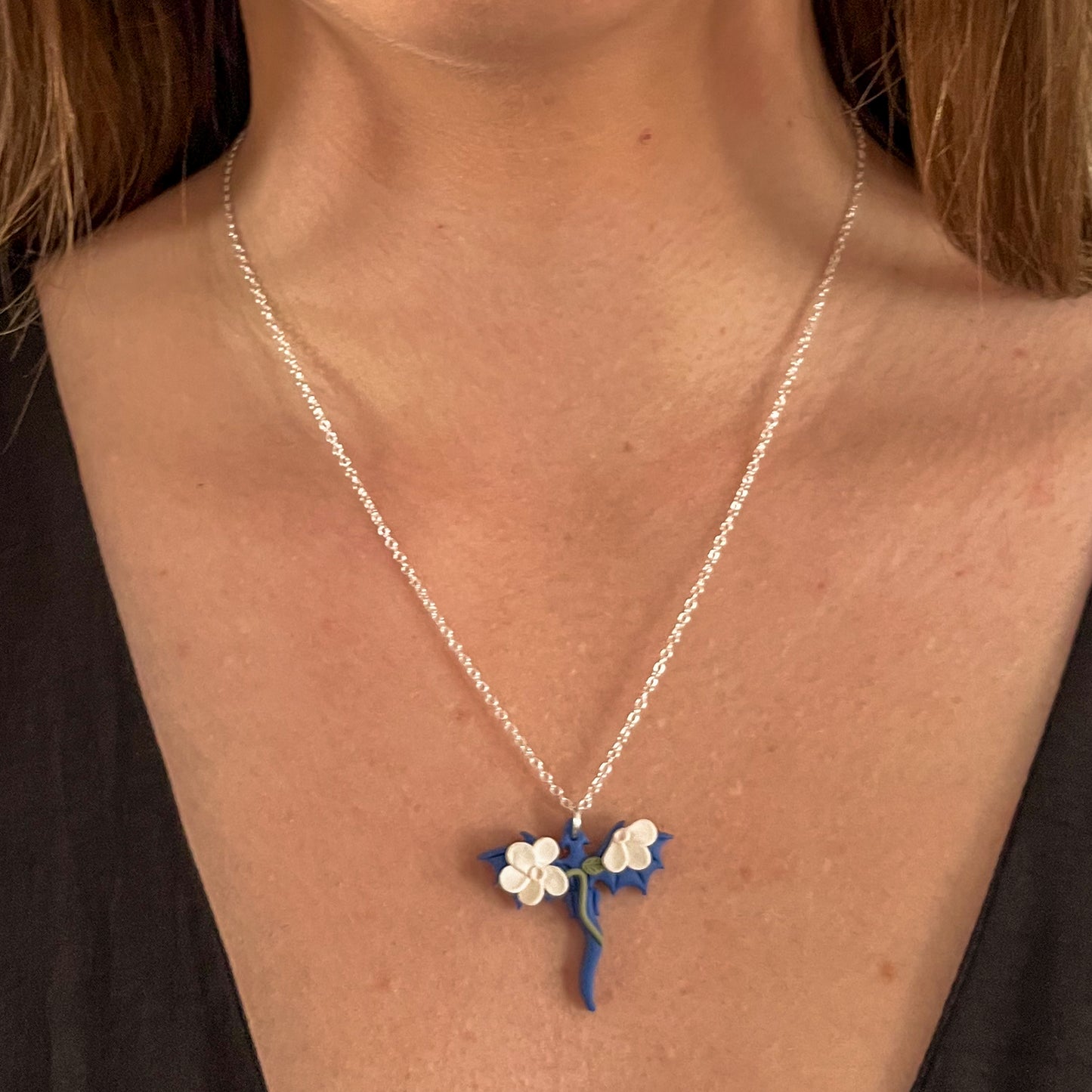 Small blue dragon necklace with white floral details | 18" chain
