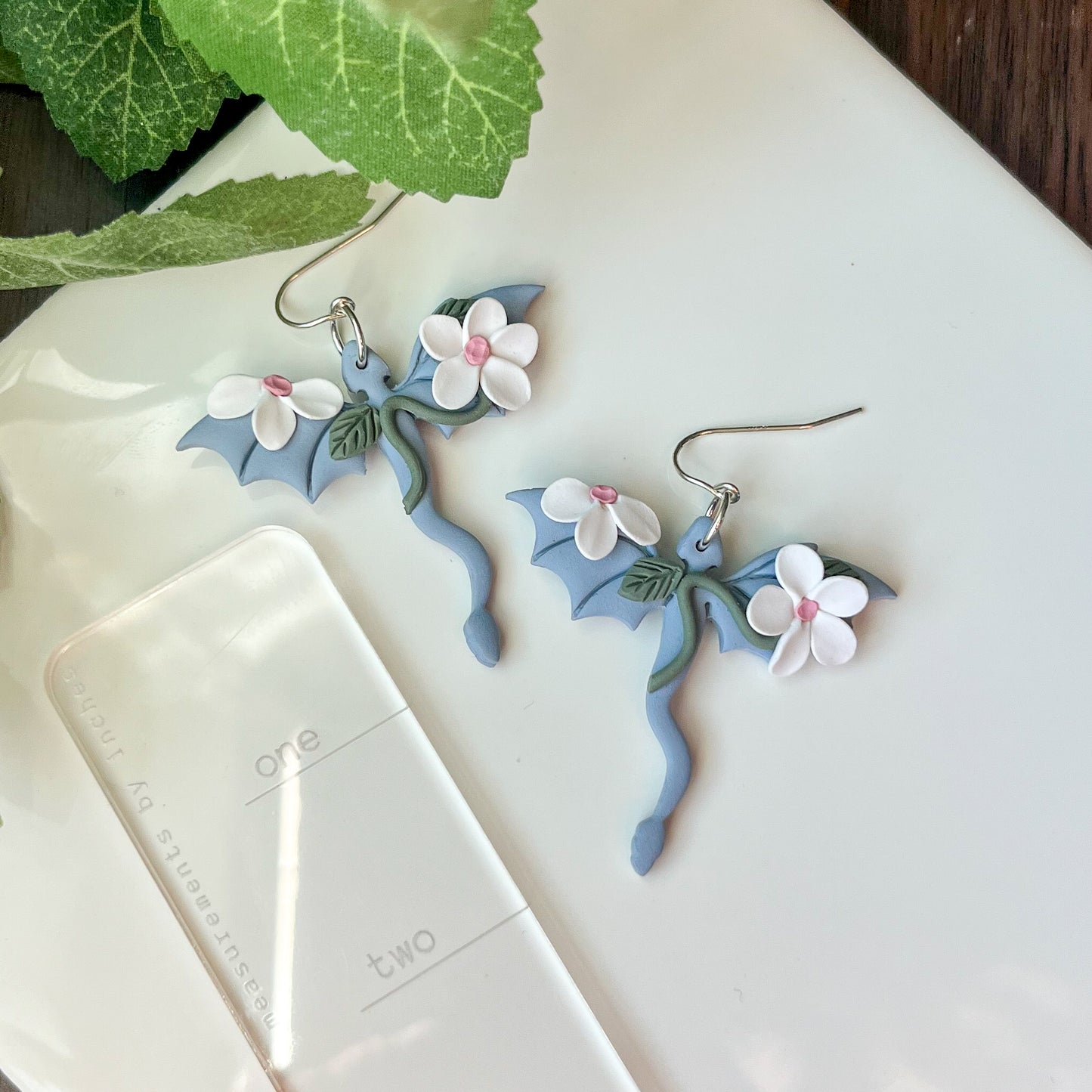 Sky blue dragon earring with white floral details | sterling silver