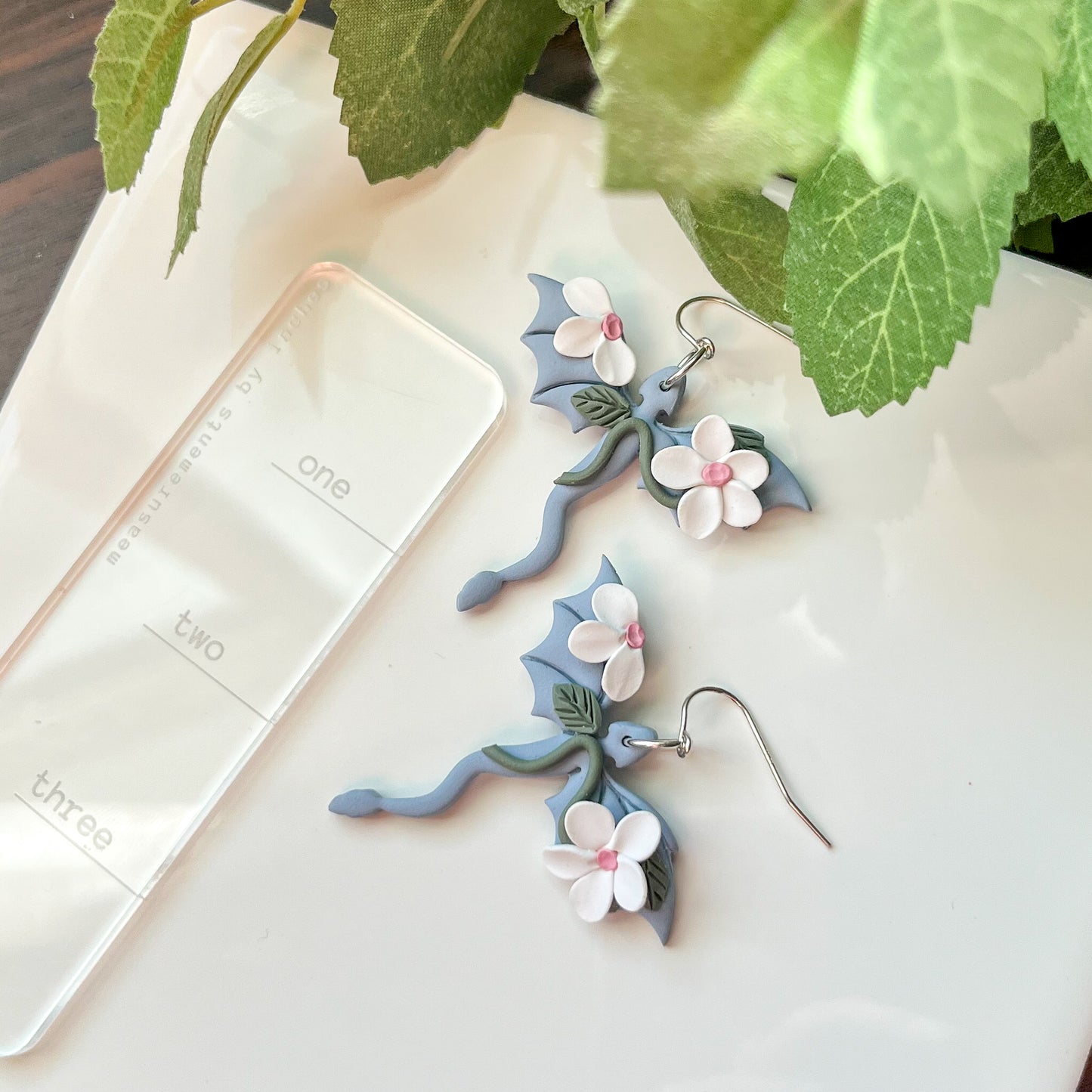 Sky blue dragon earring with white floral details | sterling silver