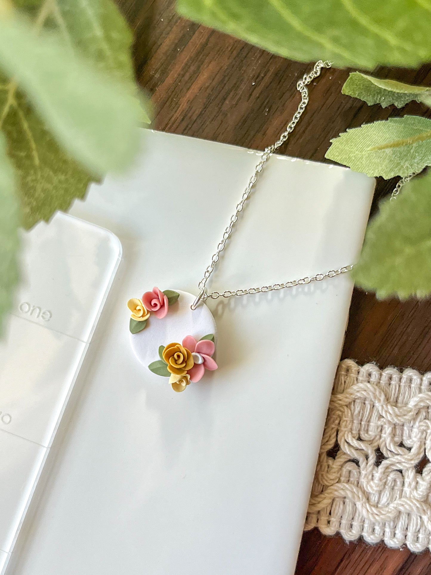 Small white medallion necklace with pink and yellow flowers | multiple metals